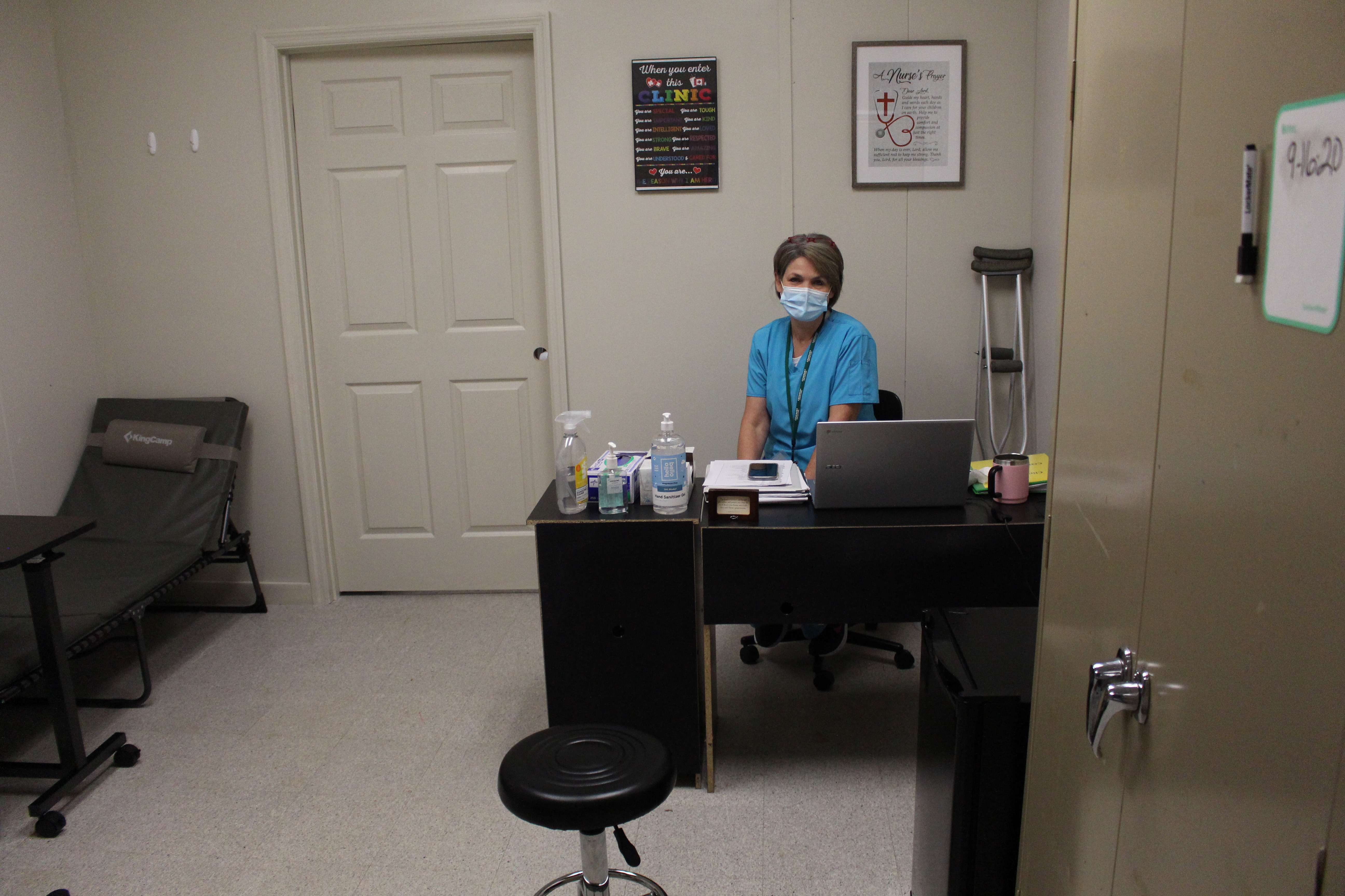 Nurse scanning a forehead with a thermometer