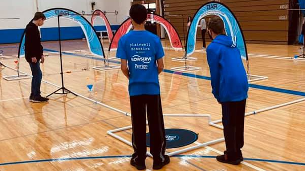 Two students at a robotics tournament.