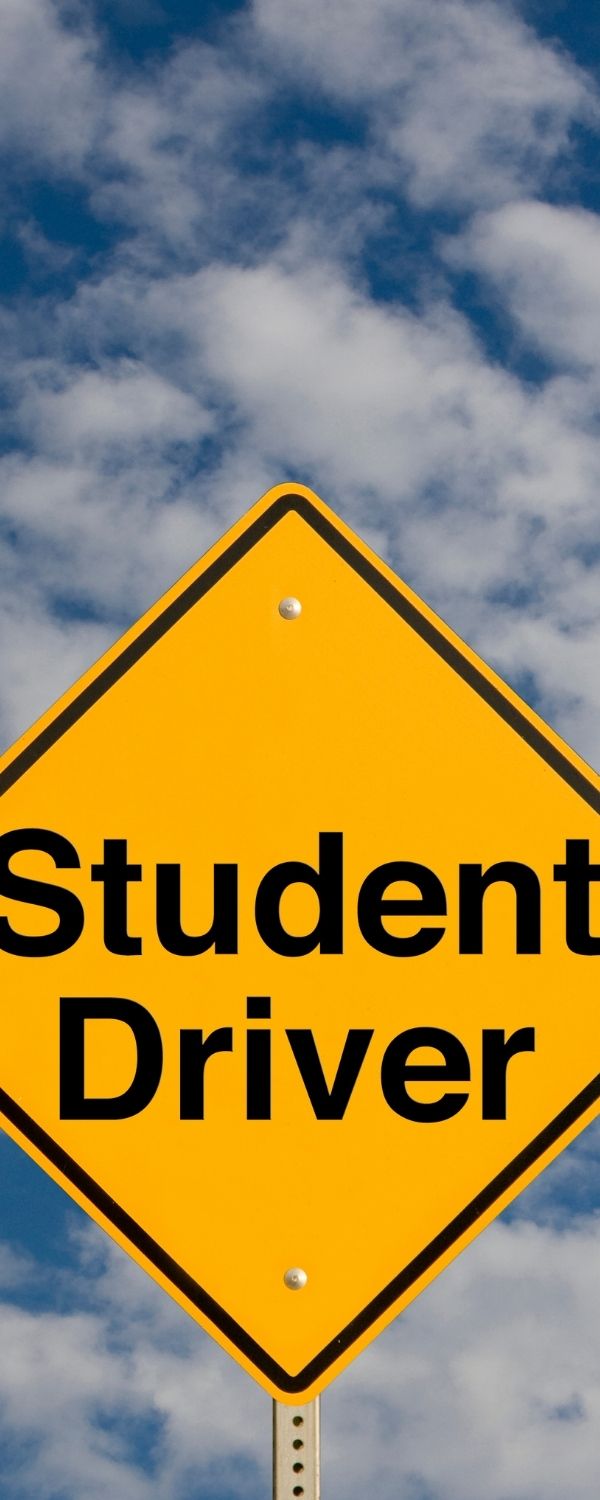 Picture of sky with a road signing saying "Student Driver"