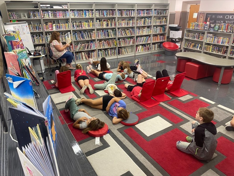 Grade school class enjoying read-aloud