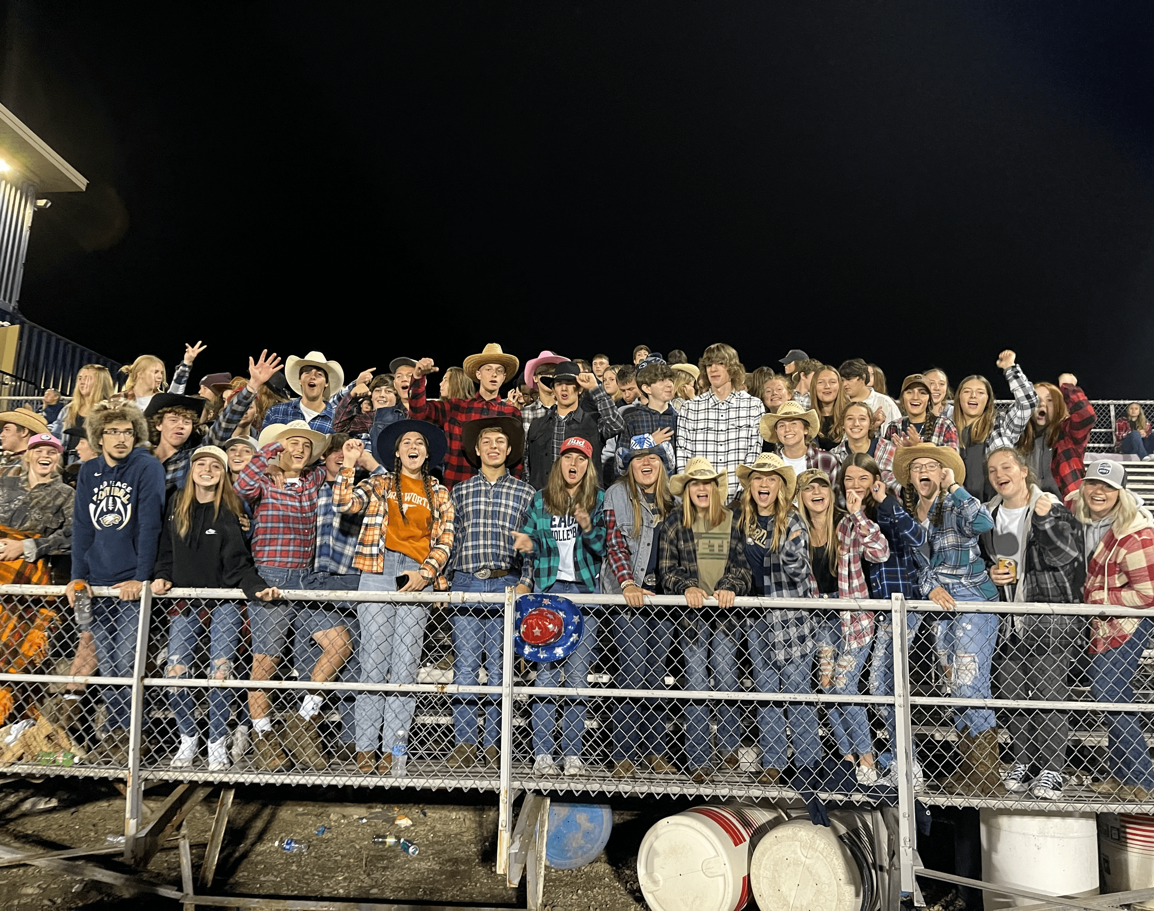 Students dressed up in flannels and cowboy hats at a rodeo!