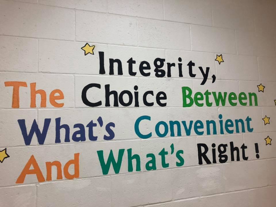 a photo of a wall that says "integrity, the choice between what's convenient and what's right"