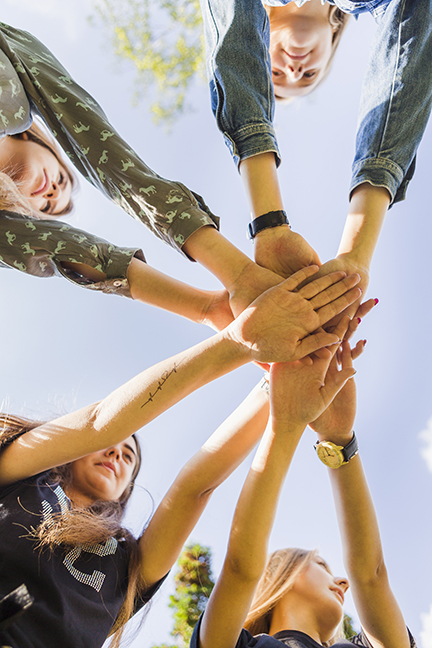 group of friends with hands outreached