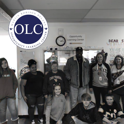 Students in hall with OLC logo