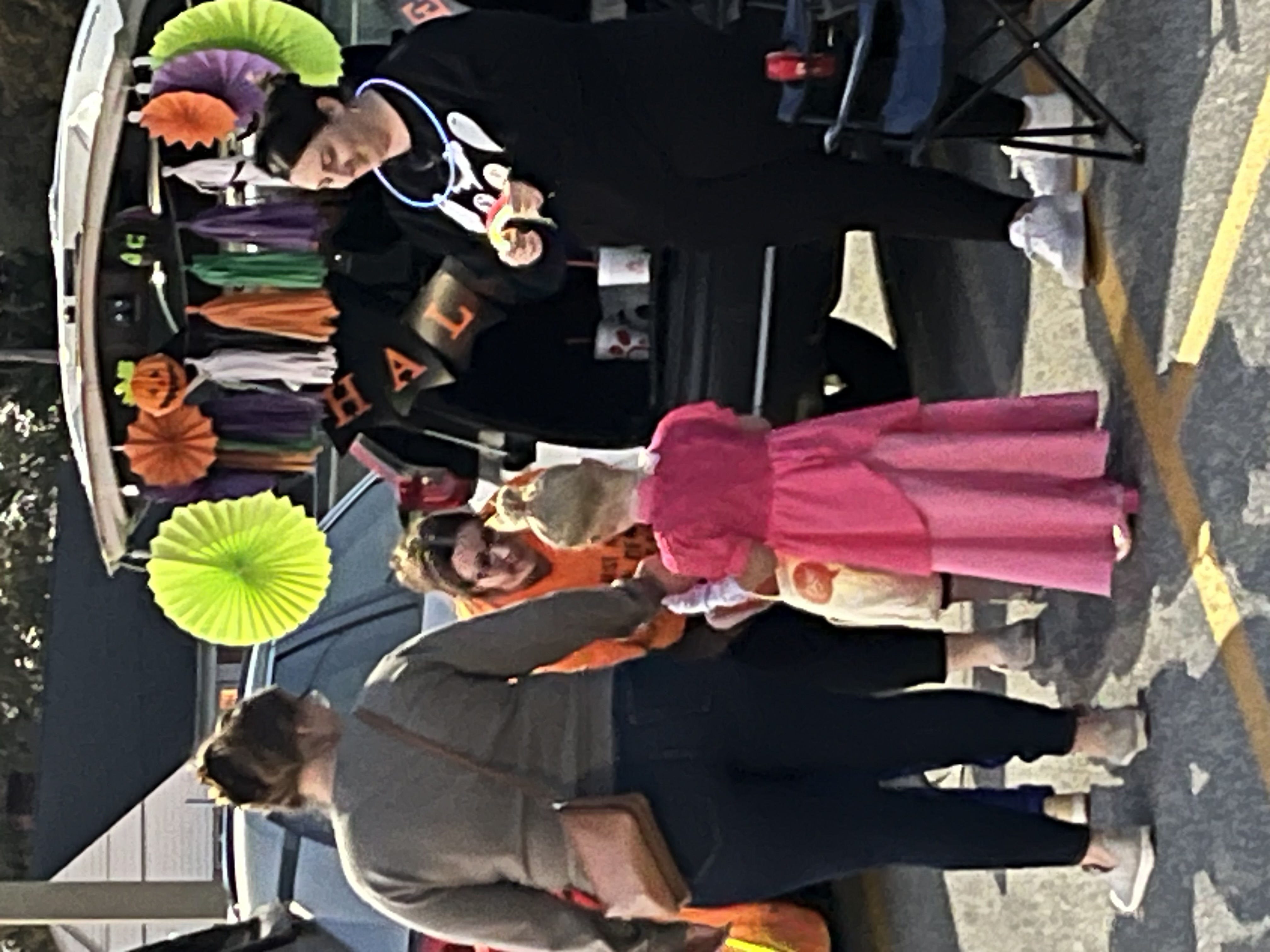 people in costumes at trunk or treat