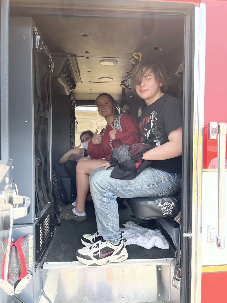 Students sitting in fire truck