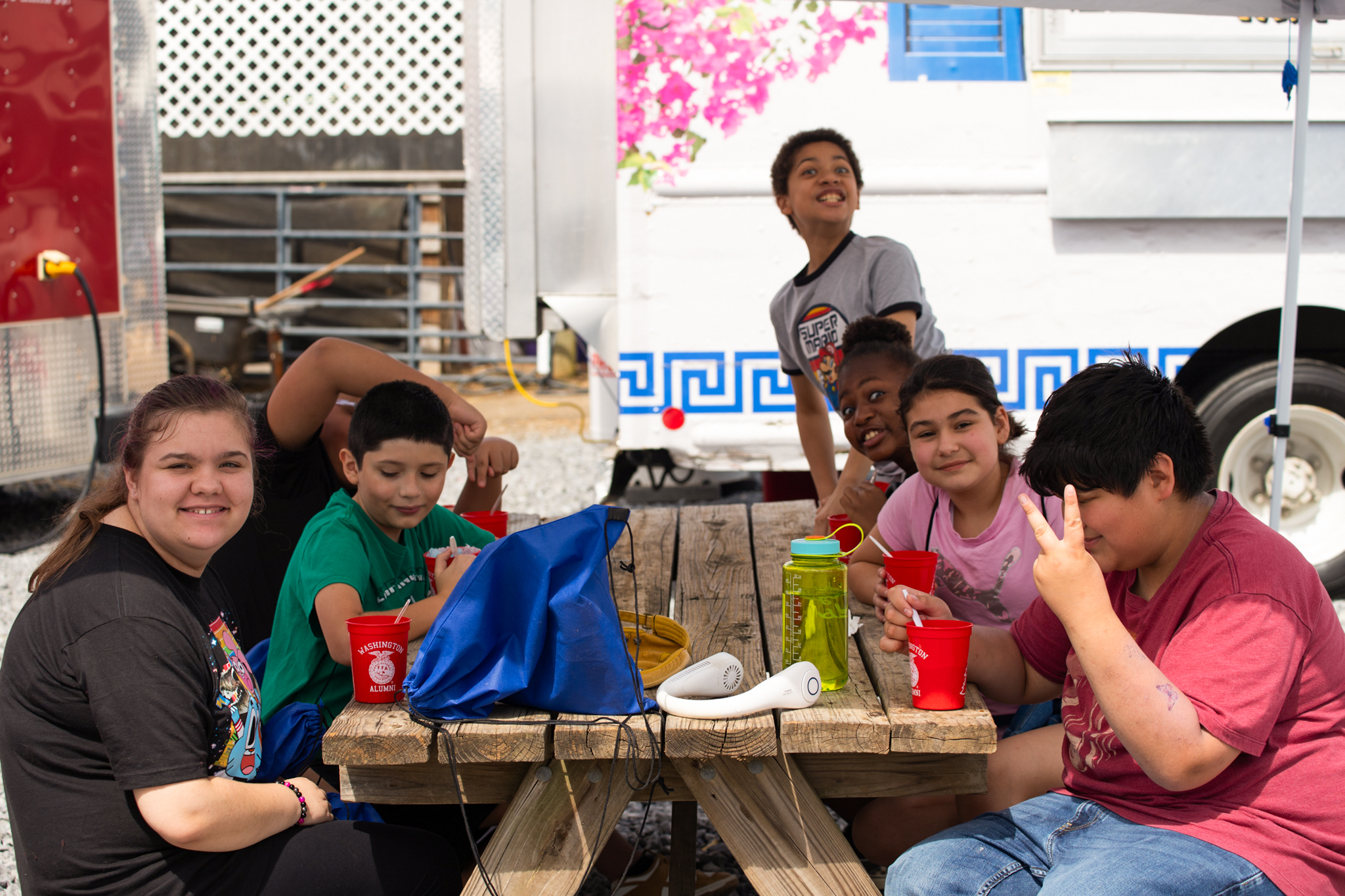 students outside eating at a picnic at the fair