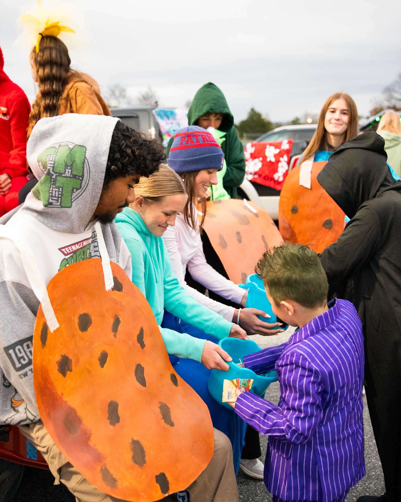 Student trick-or-treating from high school students