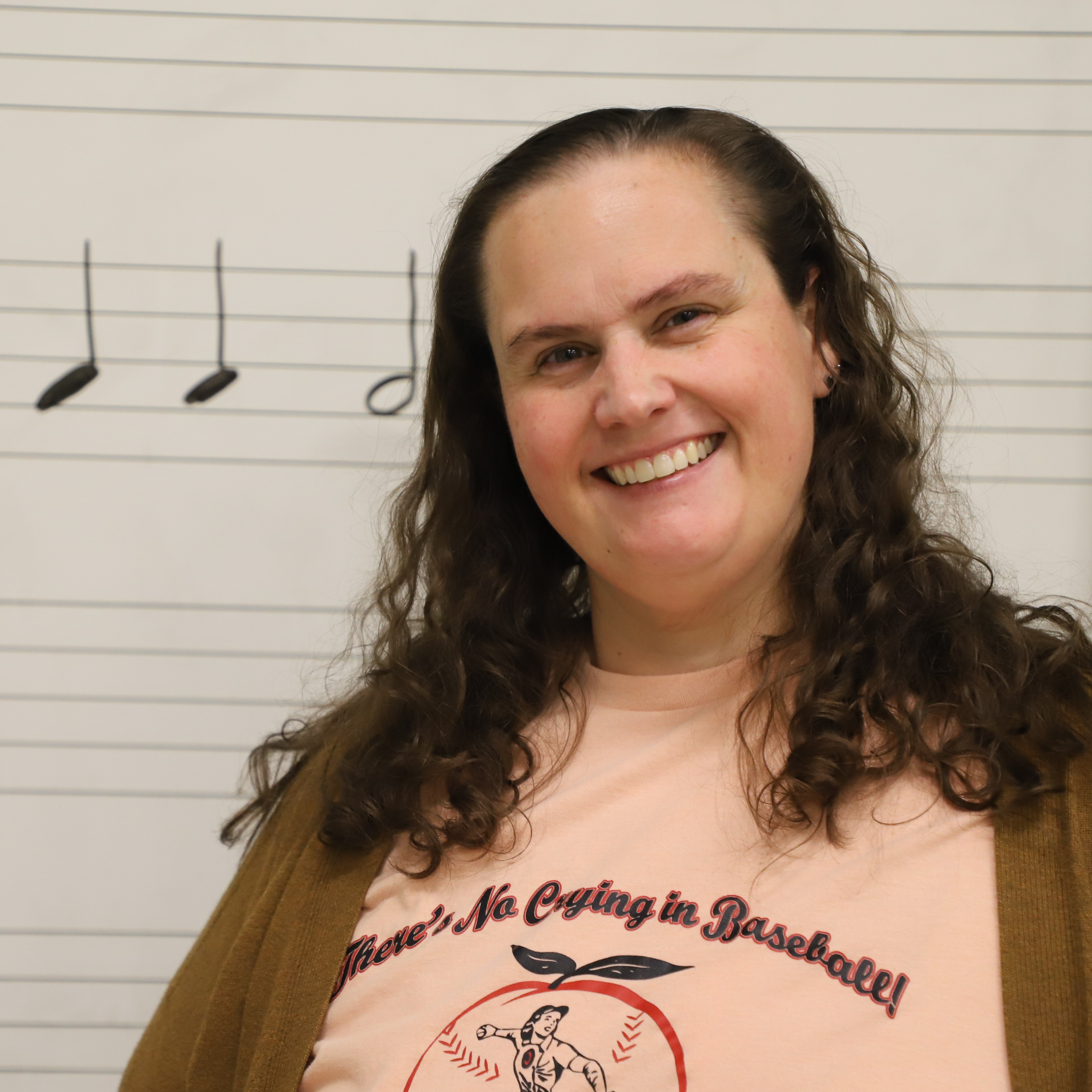 Angela Wyatt, Teacher of the Year Headshot in front of music classroom whiteboard.