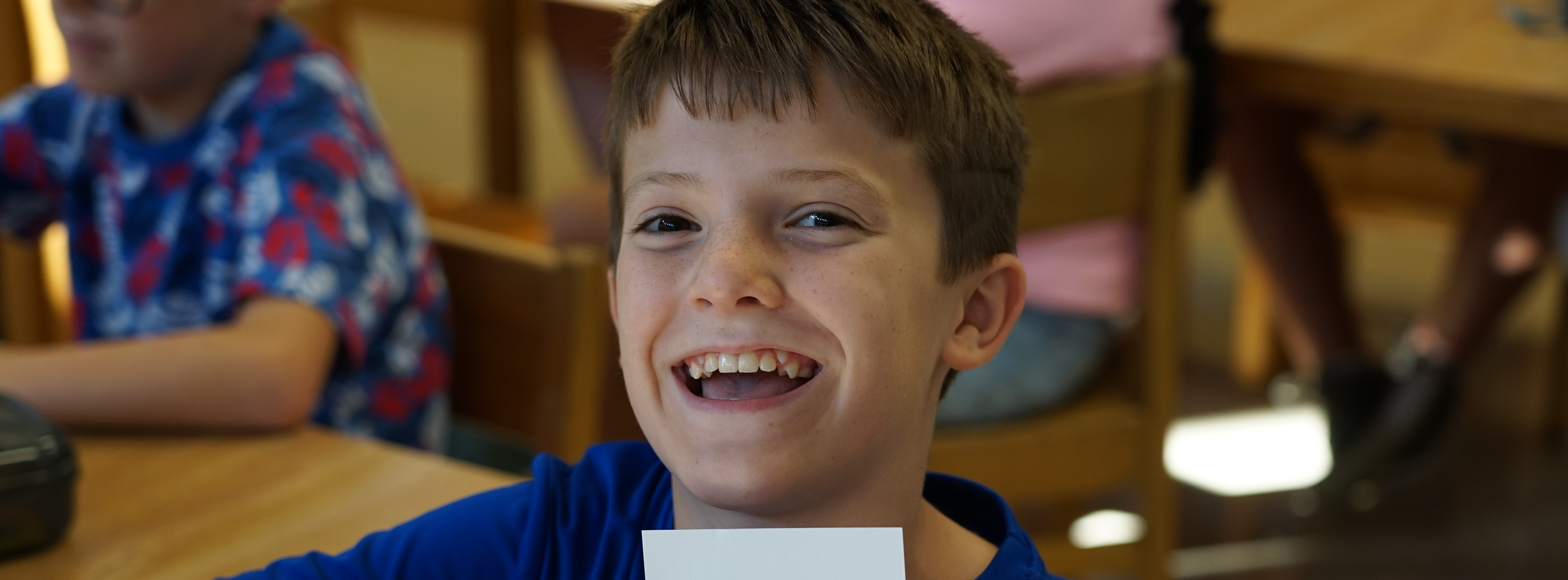 Boy in library posing and smiling at camera