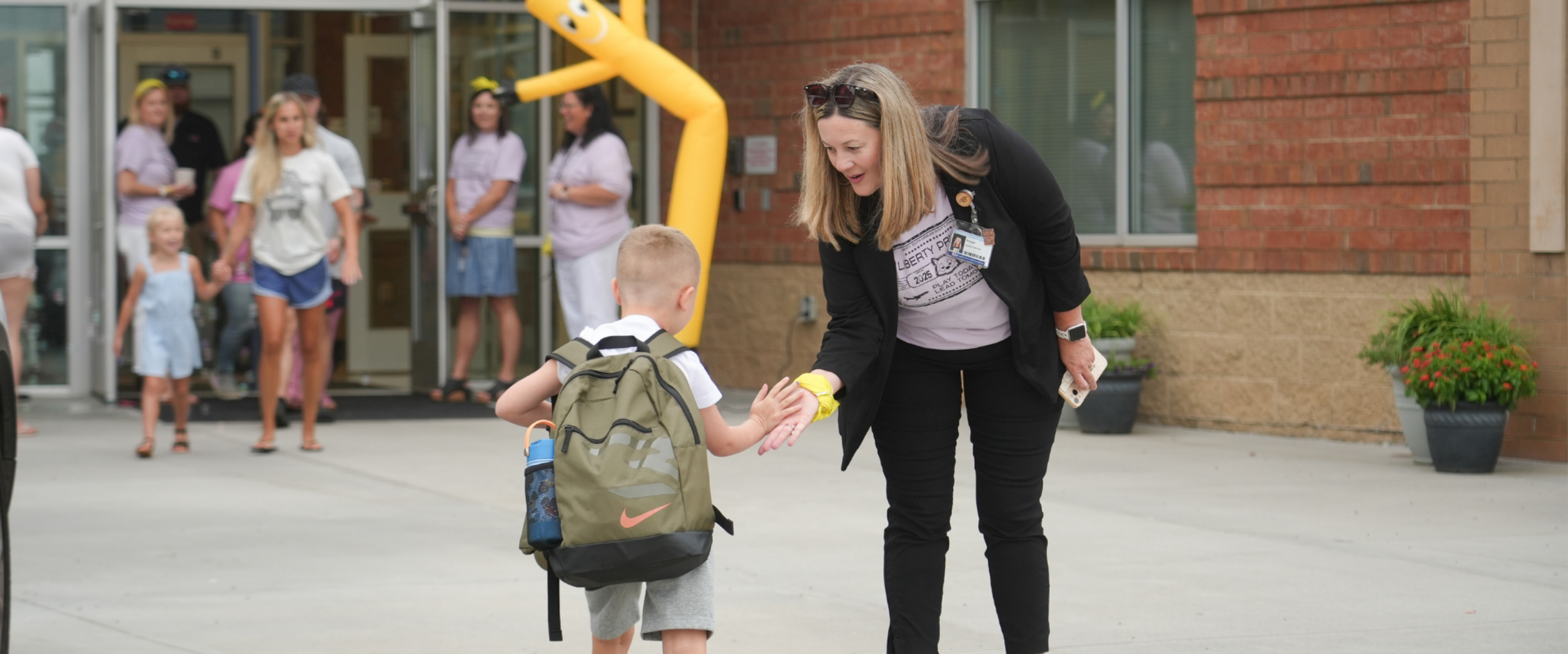 Principal giving student a high five 