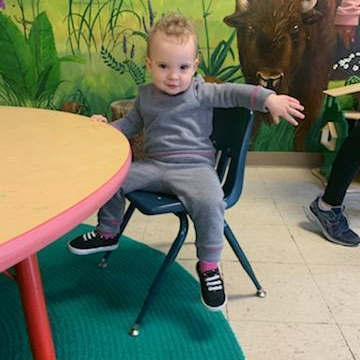 Birth to 3 program playgroup child sitting in a chair posing