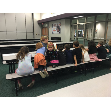 Young students sitting a long table