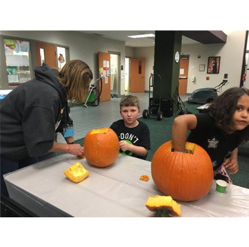 Students cleaning out pumpkins