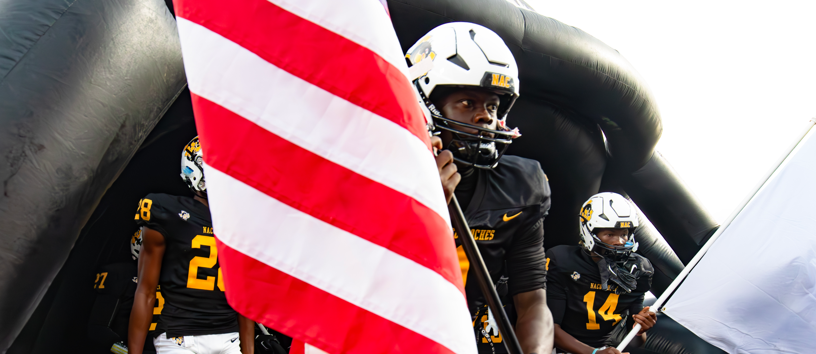 Images of football players, cheerleaders, band, and drill team from the Nacogdoches vs Palestine game