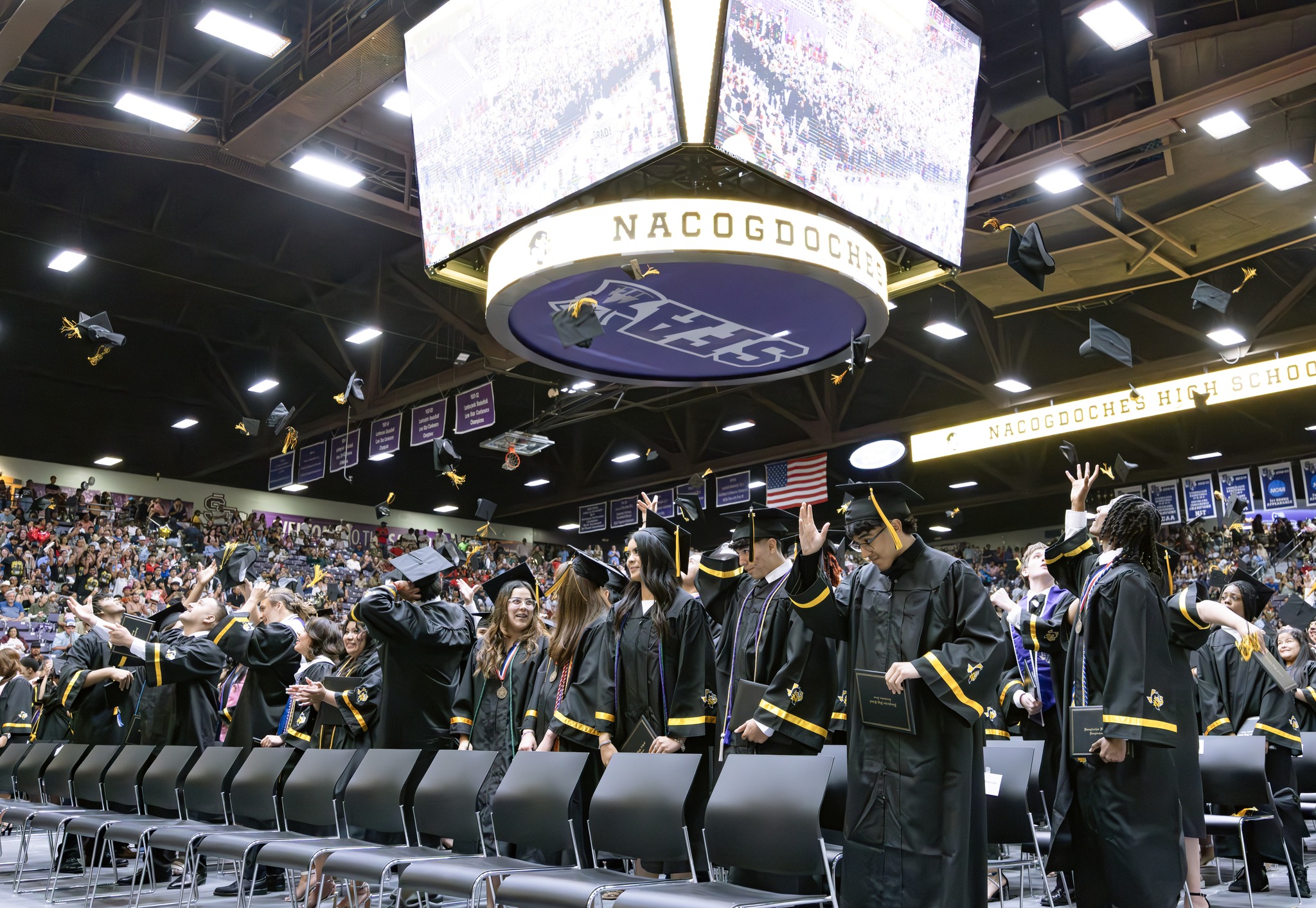 NHS graduation - students throwing caps