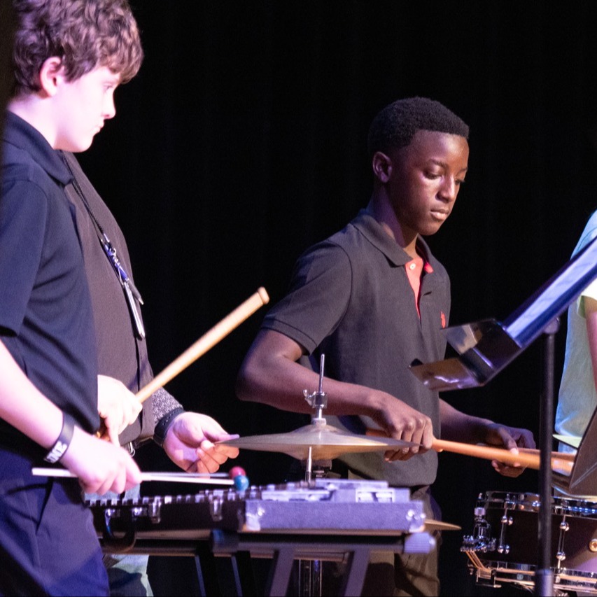 Percussion students performing on stage at fine arts showcase
