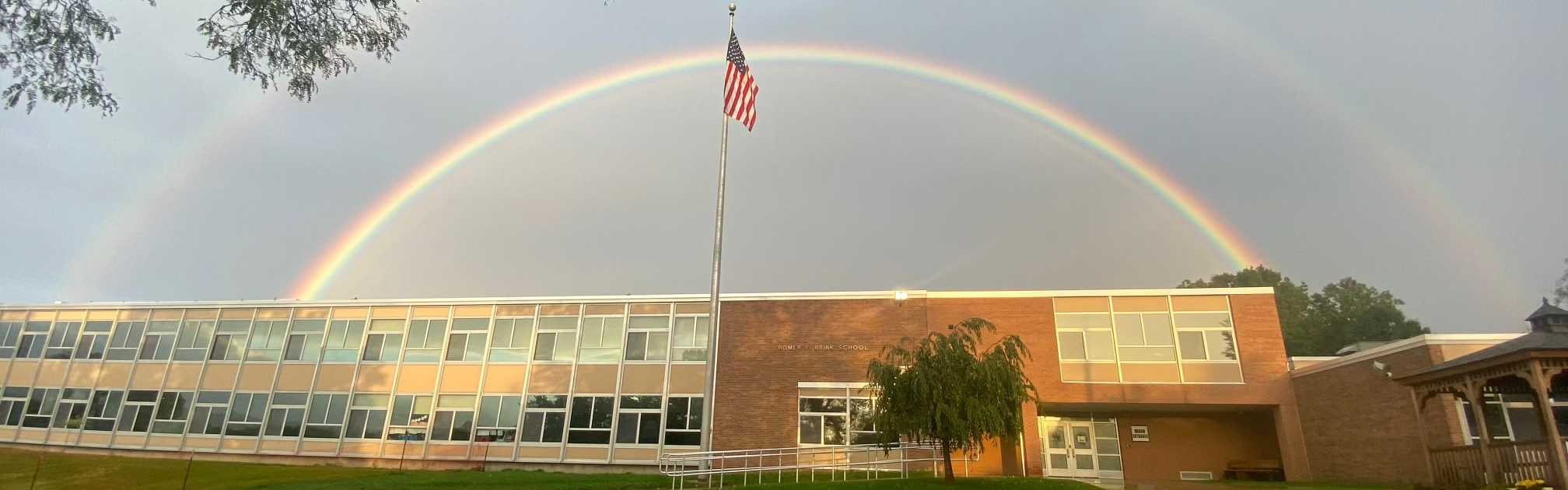 School building with rainbow above it
