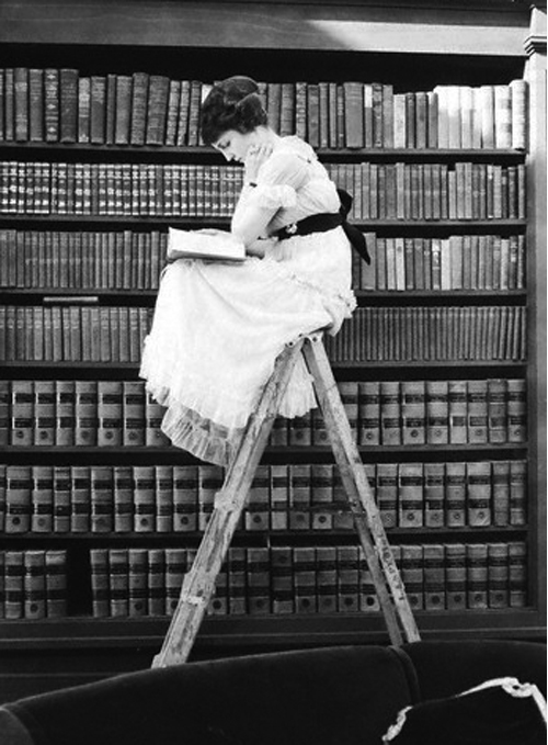 Black and white photo of a girl reading