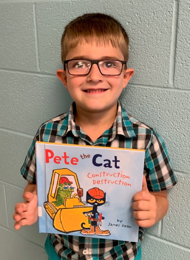 A student holding up a book