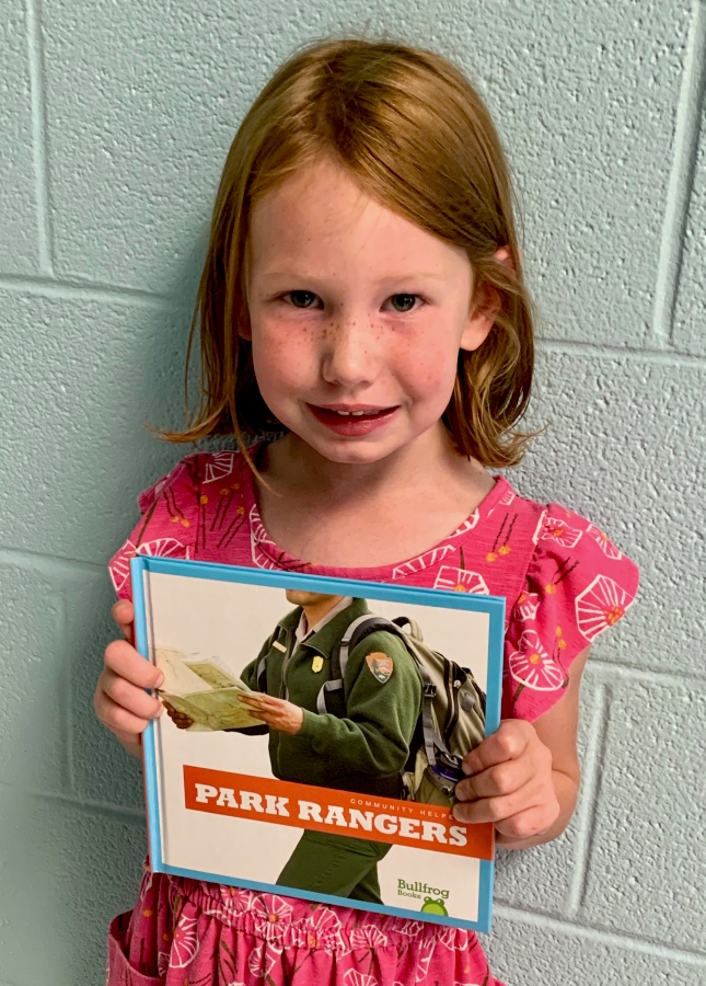 A student holding up a book