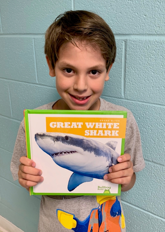 Student holding up a book