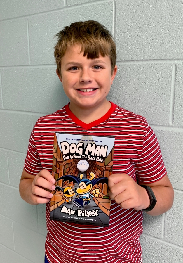 Student holding up a book