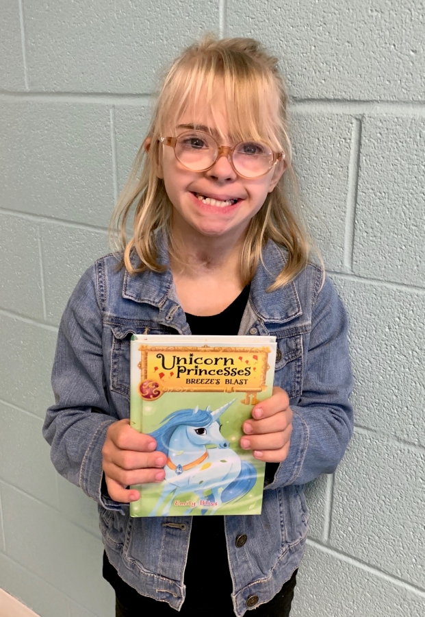 Student holding up a book