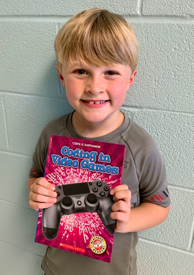 Student holding up a book