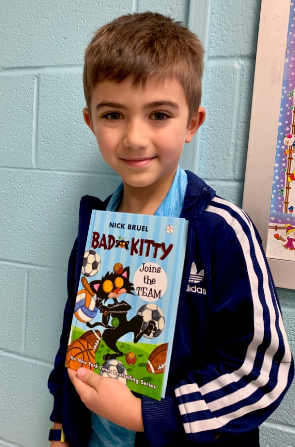 Student holding up a book