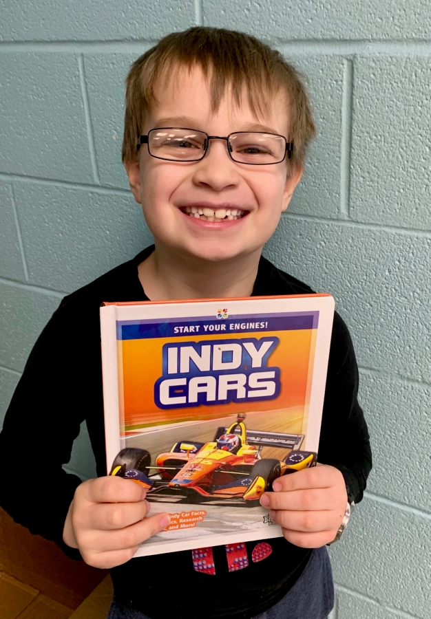 Student holding up a book