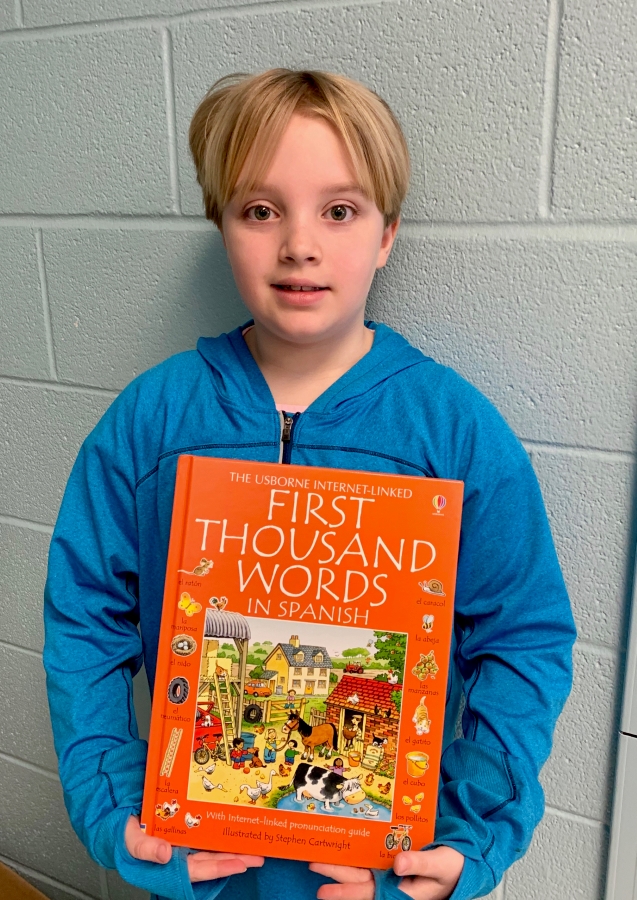 Student holding up a book