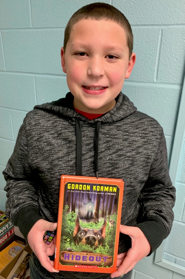 Student holding up a book