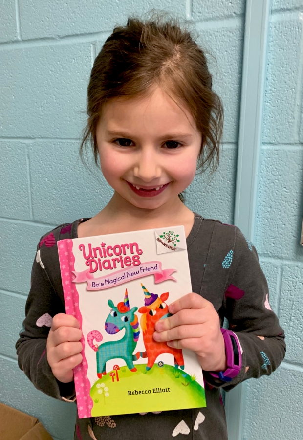 Student holding up a book