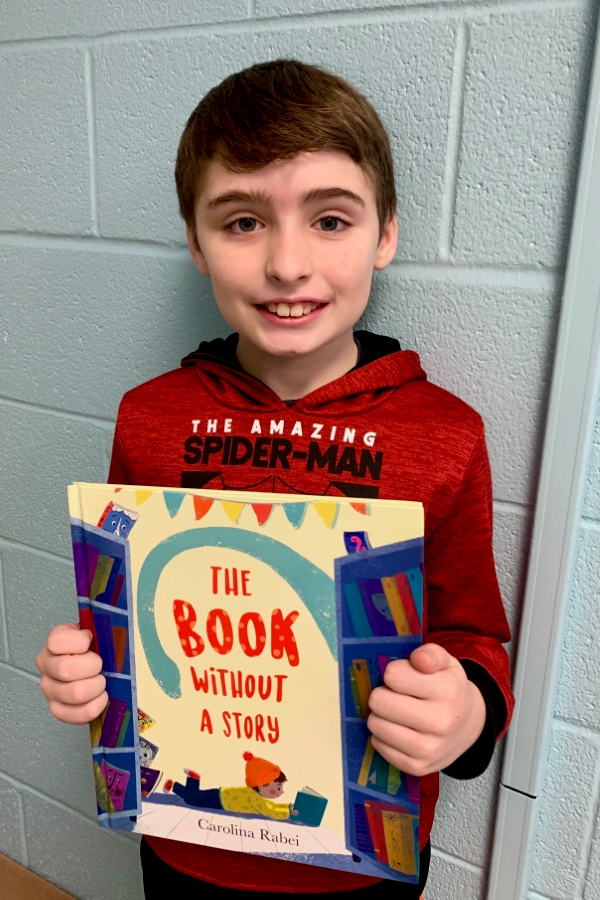 Student holding up a book