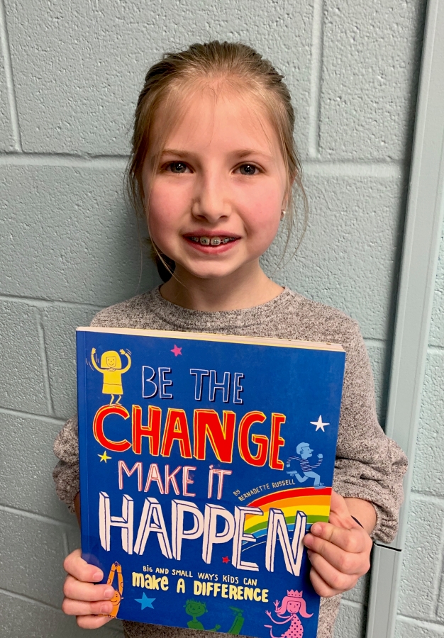 Student holding up a book