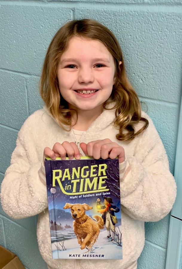 Student holding up a book