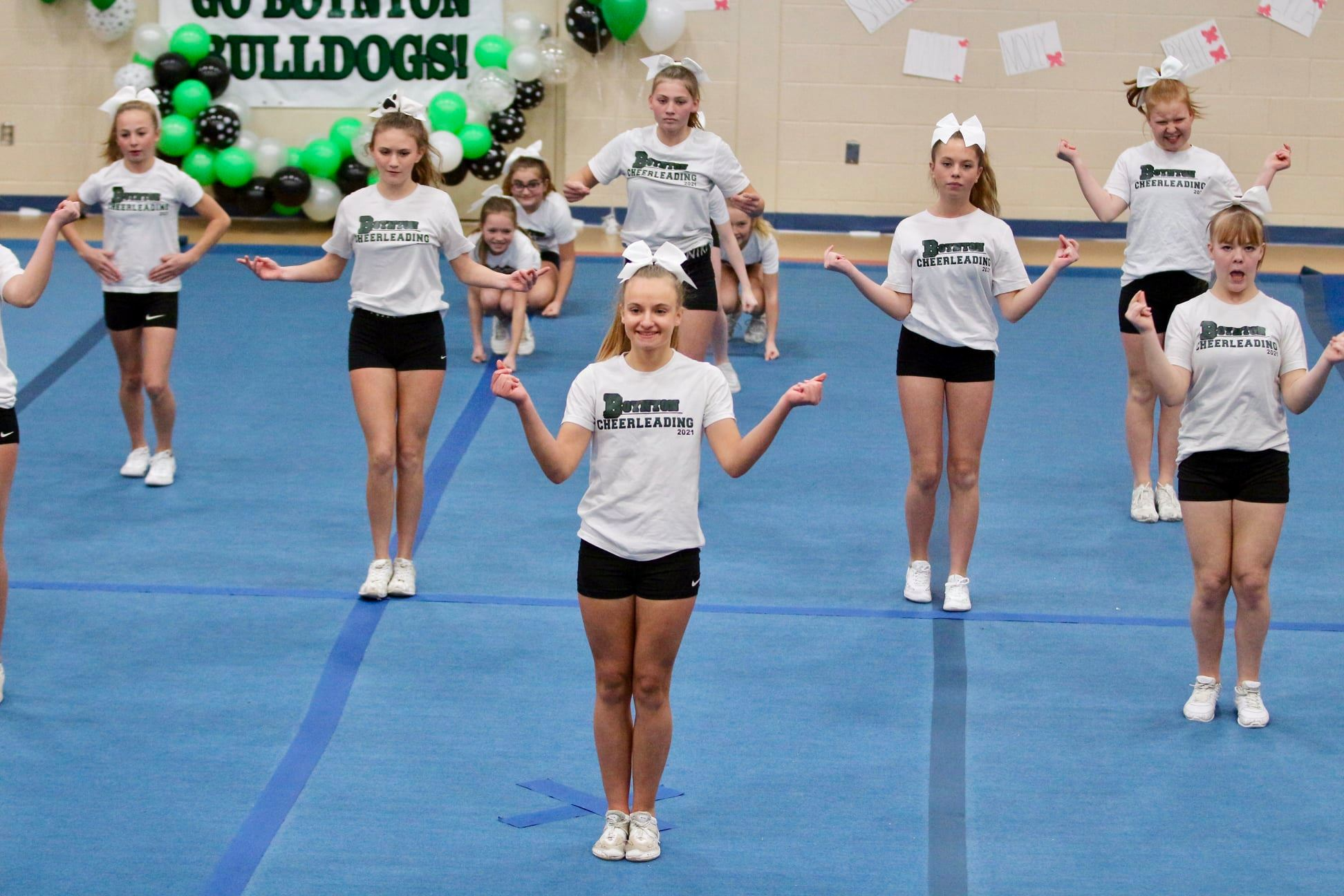 Image of the Boynton Cheerleading team performing a routine at a competition. 