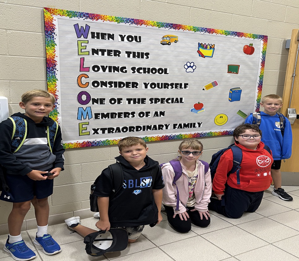 Students at Welcome sign First Day of School