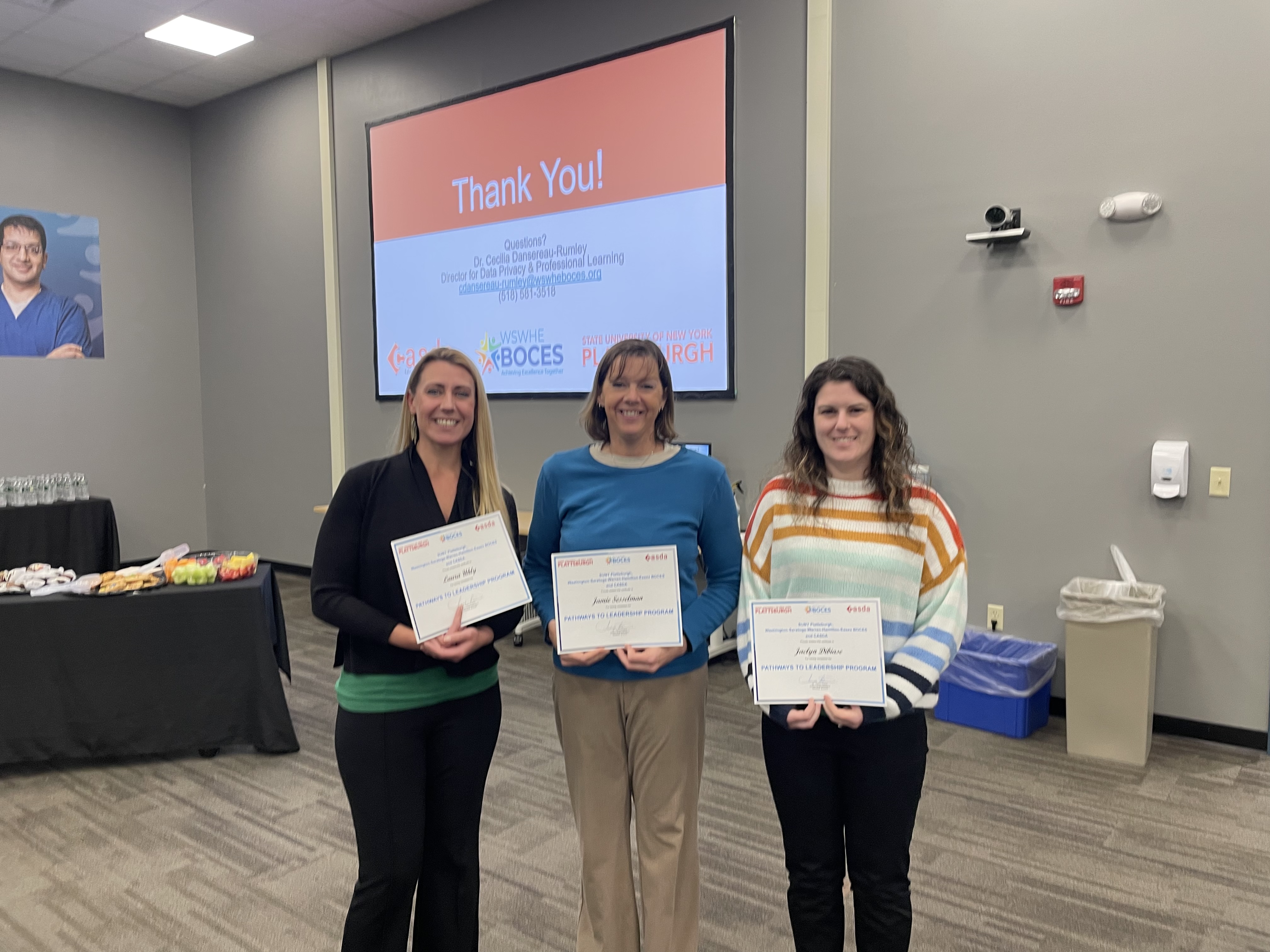 three WCSD teachers with their certificates of completion