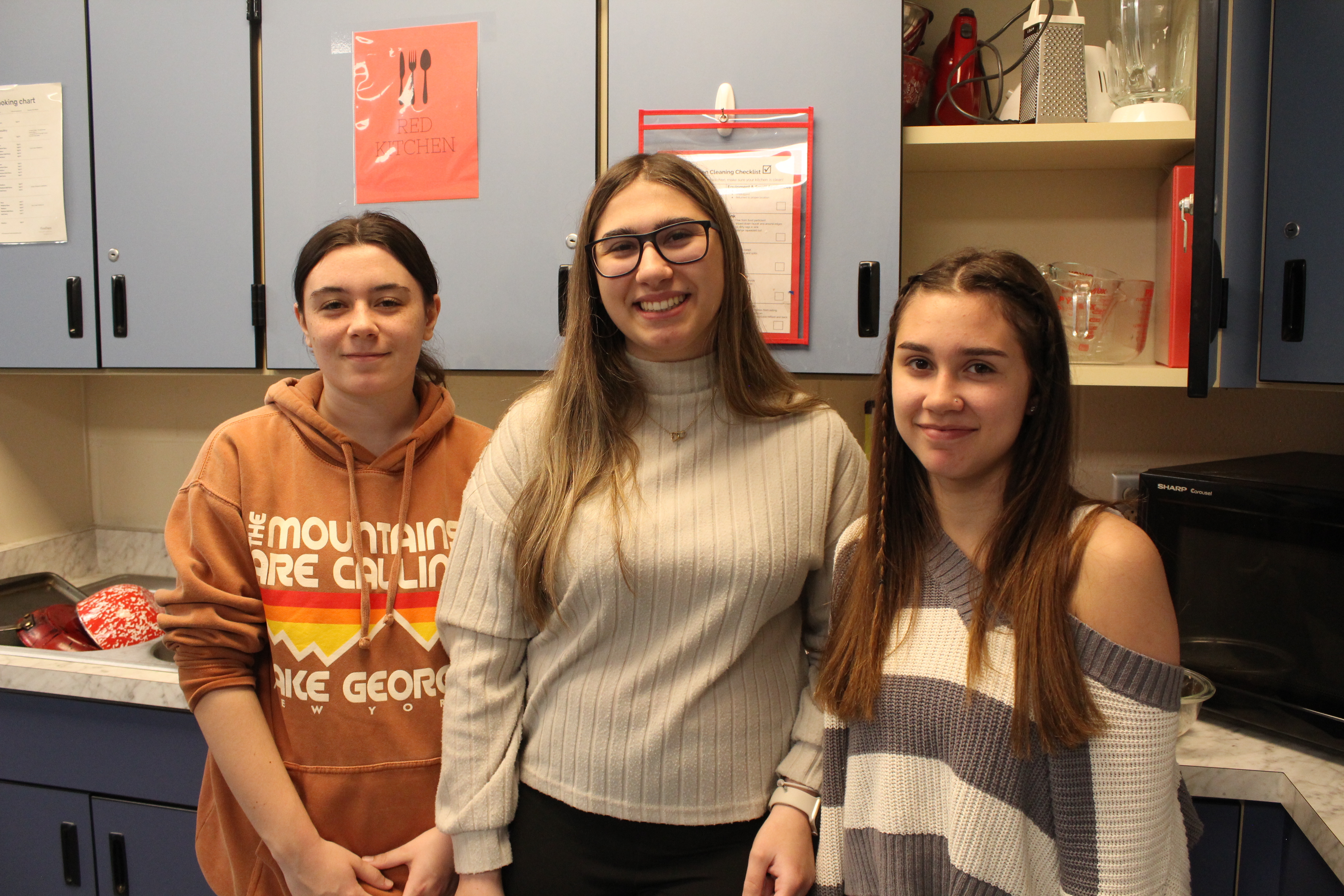 three students smiling