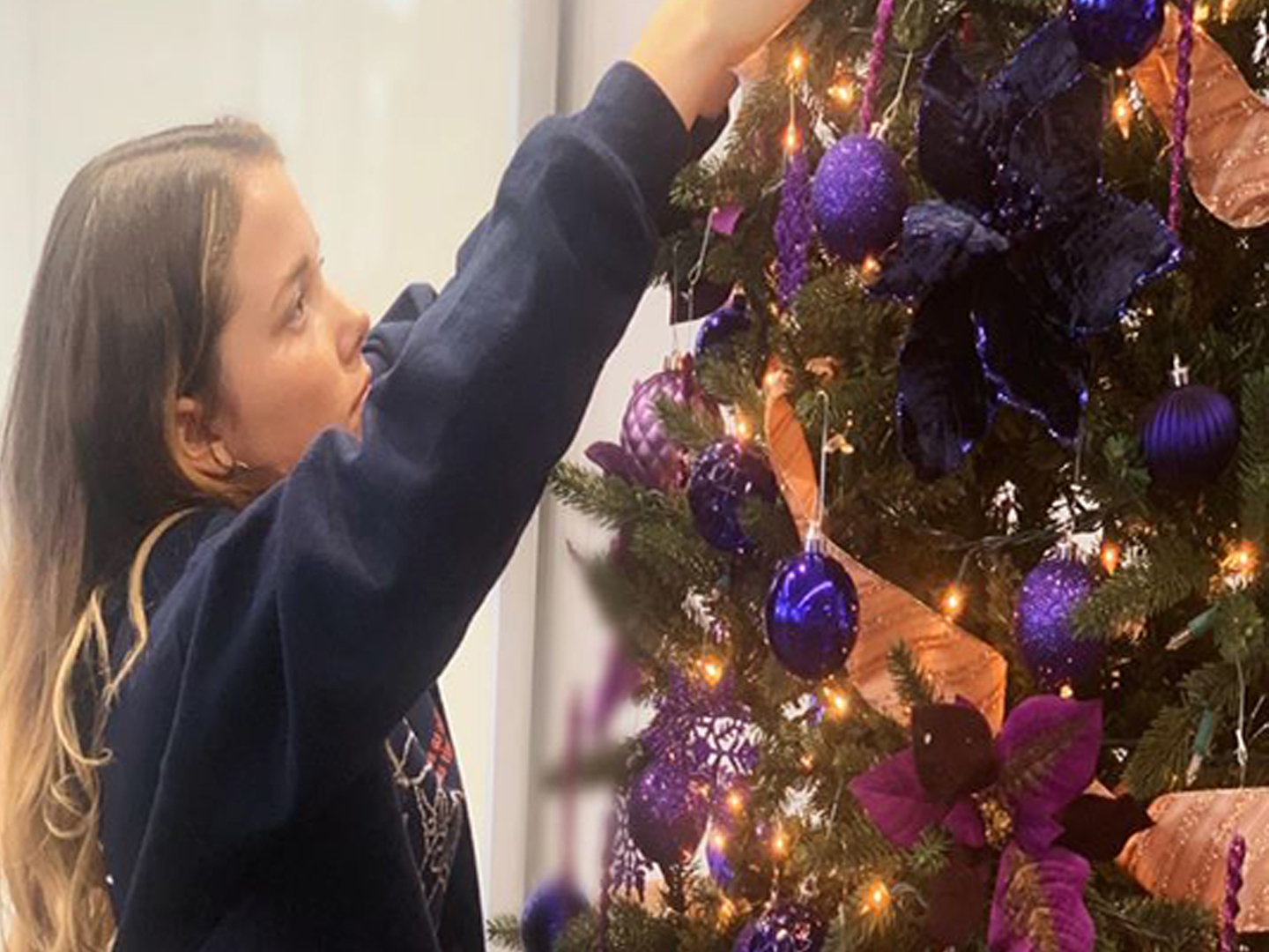 Student decorating Advent Tree