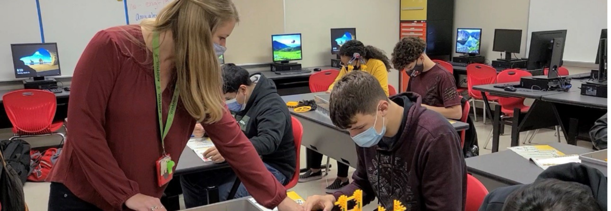 Teacher helping a student banner