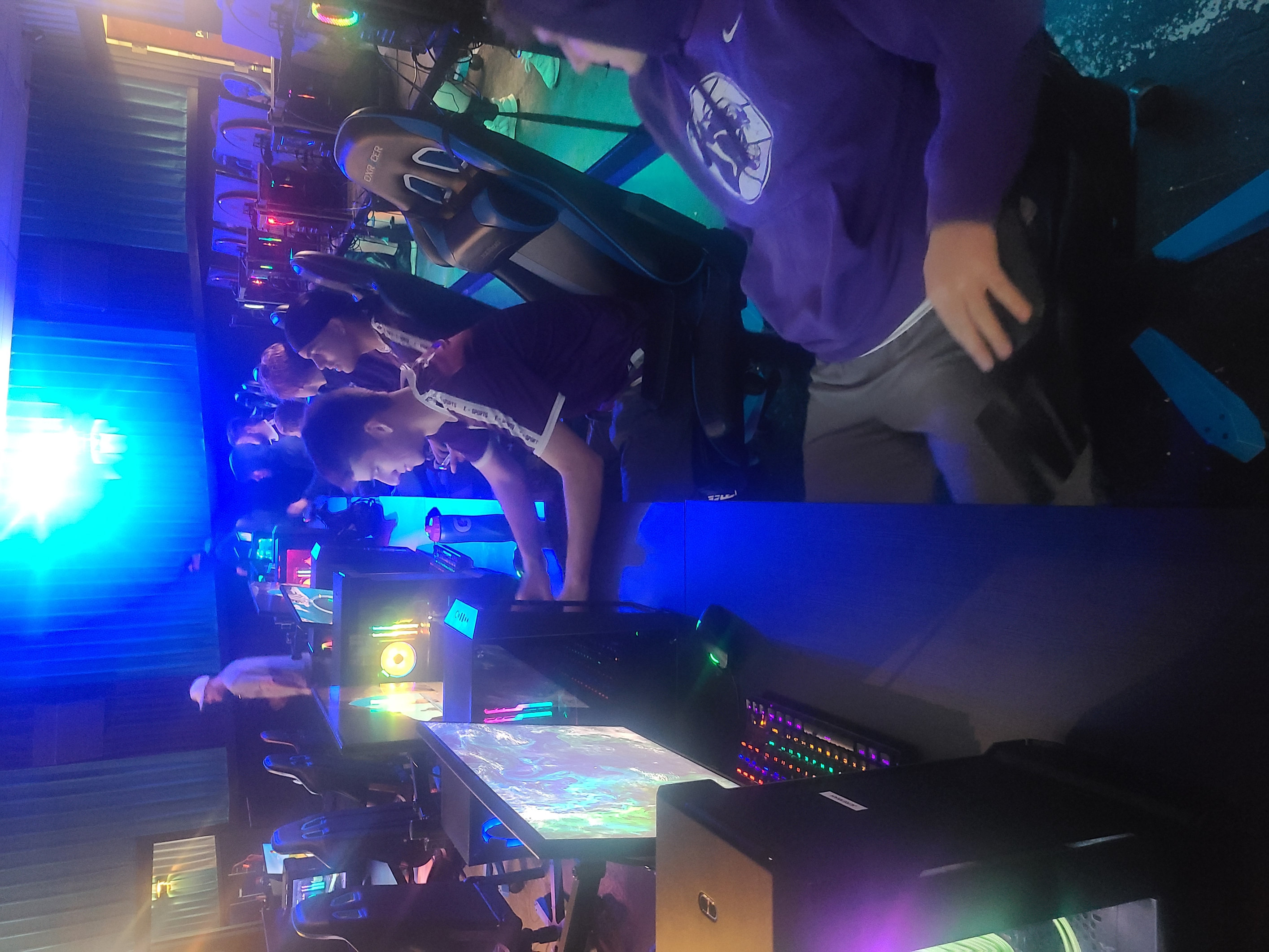 Photo of team playing video game in pc cafe