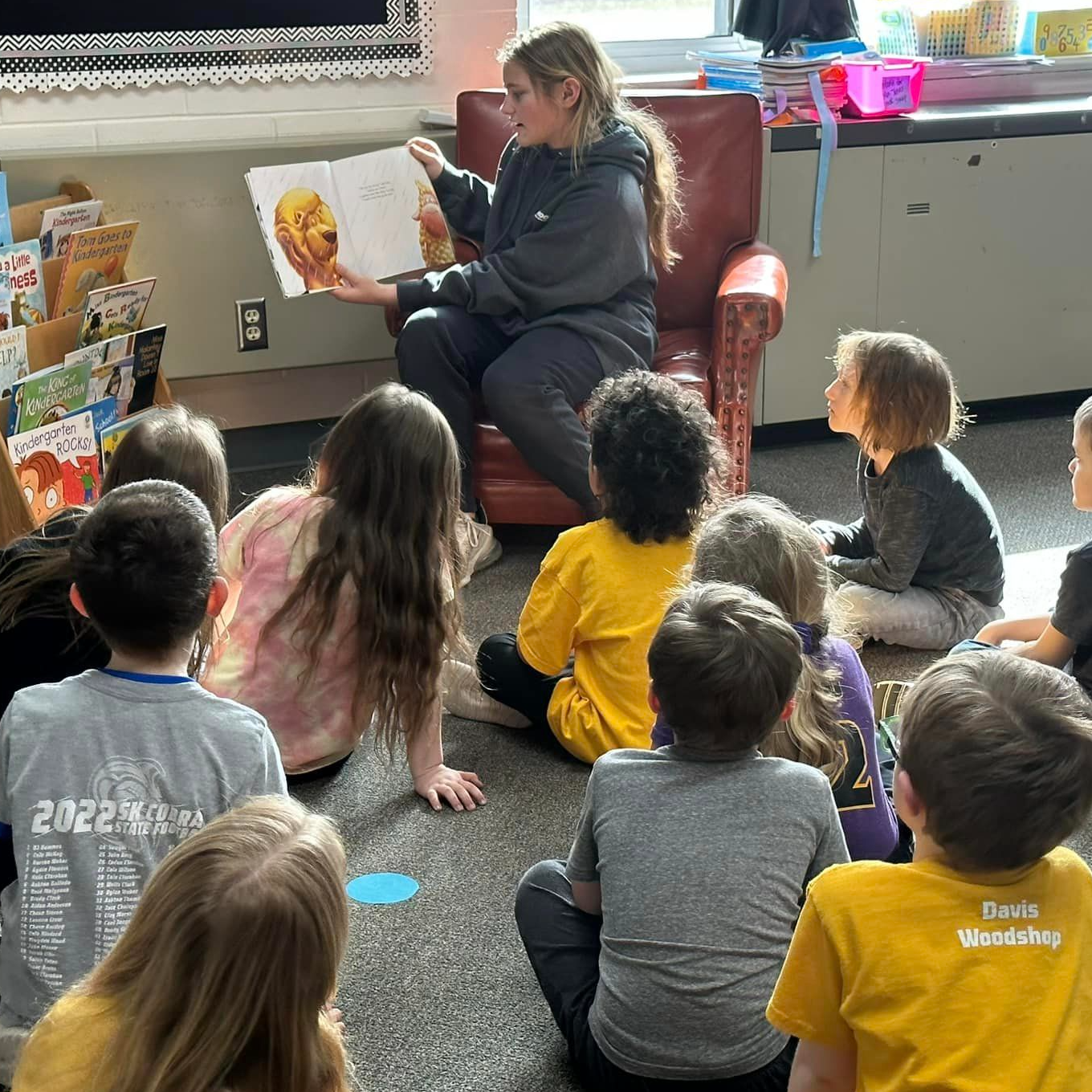 high school student reads to children