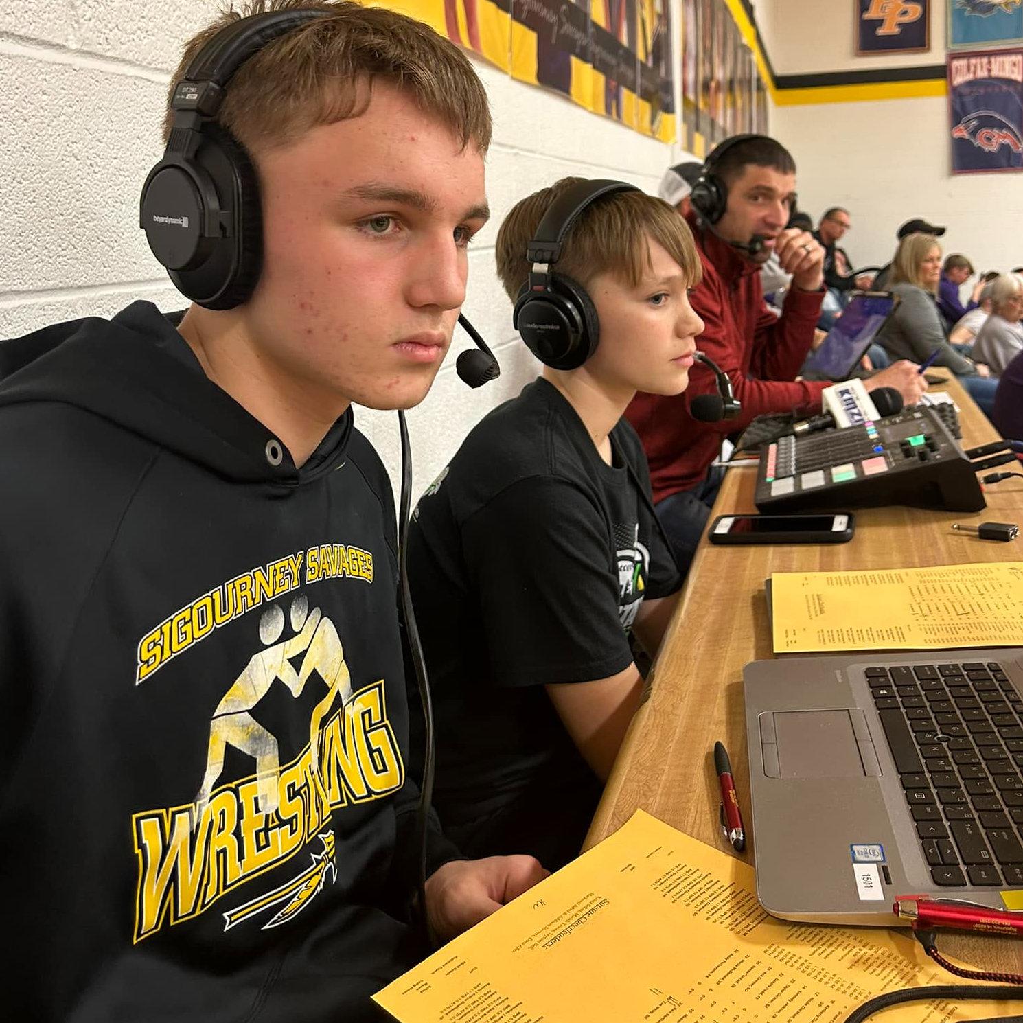 two student announcements assist with broadcast of game
