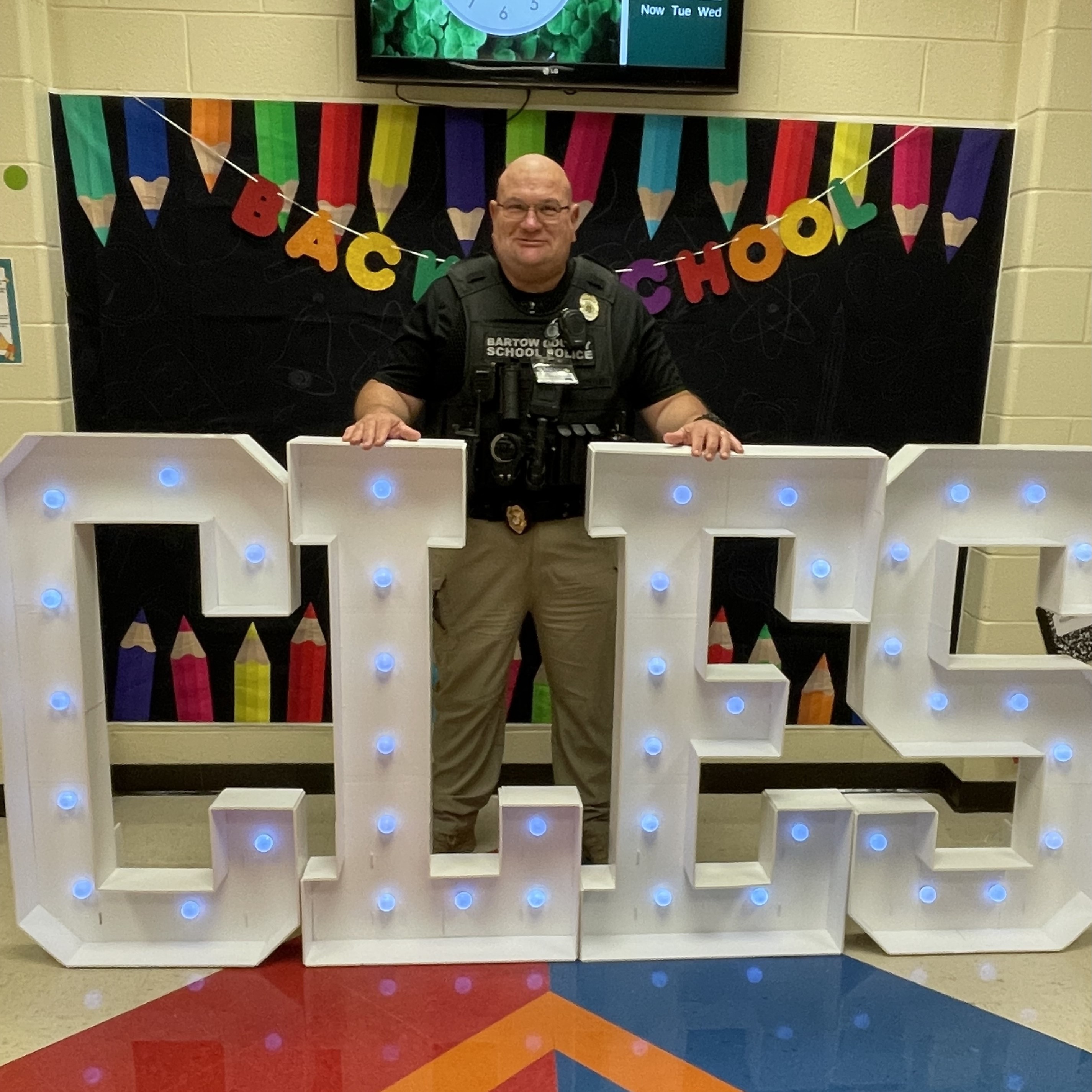 Officer Anno poses for a photo in uniform at the Back to School display