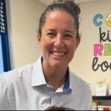 Mrs. Kerry Hammond, our assistant principal at PLES. Woman with her hair pulled back wearing a white button up shirt with blue dots
