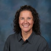 Mrs. Kerry Hammond, our assistant principal at PLES. Woman with her hair pulled back wearing a white button up shirt with blue dots