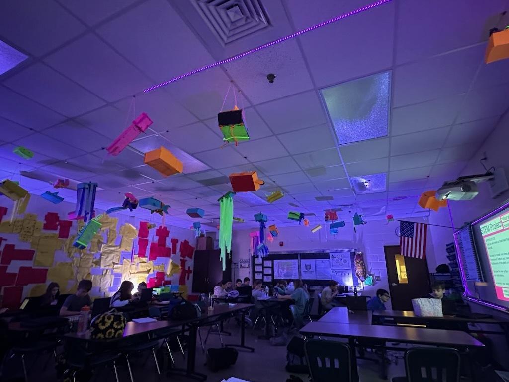 STEM glow projects hanging in room